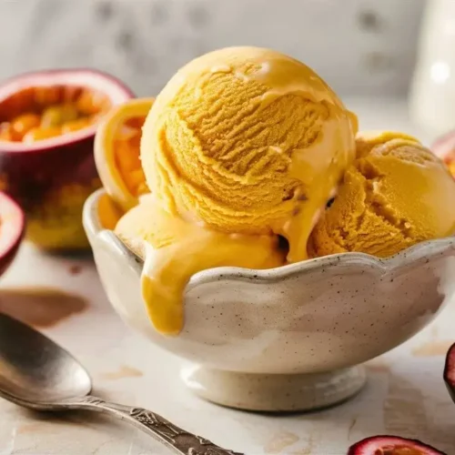 Light and refreshing passion fruit sorbet in a cup with fresh fruit garnish.